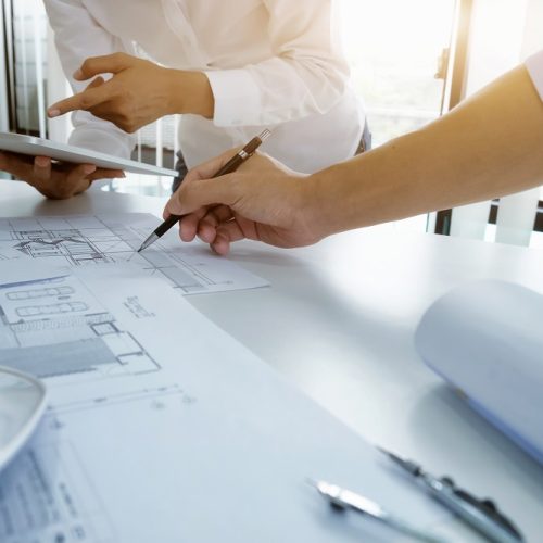 Image of engineer meeting for architectural project. working with partner and engineering tools on workplace vintage tone.
